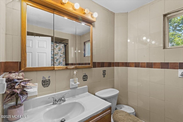 1015 Mattison Ave, Asbury Park, NJ 07712 - bathroom with tile walls, vanity, and a shower with shower curtain
