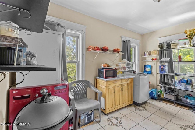 1015 Mattison Ave, Asbury Park, NJ 07712 - kitchen with black microwave, light tile patterned flooring, and healthy amount of natural light