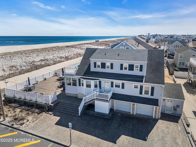 2400 Ocean Front, Lavallette, NJ 08735 - view of front of house featuring a shingled roof, an attached garage, and view of water and beach