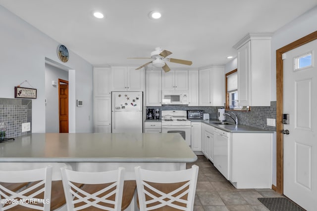 2400 Ocean Front, Lavallette, NJ 08735 - kitchen featuring white appliances, a peninsula, plenty of natural light, white cabinetry, and recessed lighting