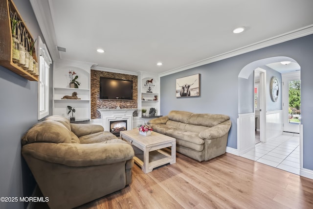 41 Alan Ter, Howell, NJ 07731 - living room with arched walkways, built in shelves, crown molding, light wood-type flooring, and recessed lighting