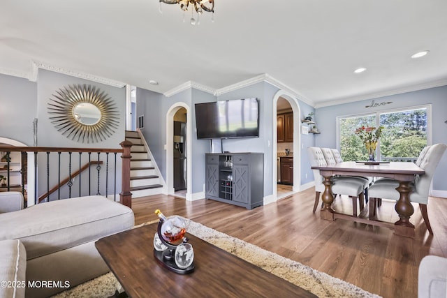 41 Alan Ter, Howell, NJ 07731 - living area with arched walkways, wood finished floors, crown molding, recessed lighting, and stairs