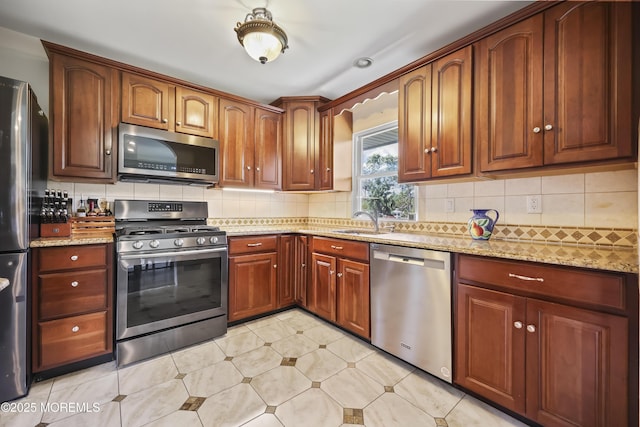 41 Alan Ter, Howell, NJ 07731 - kitchen with appliances with stainless steel finishes, light stone counters, and backsplash