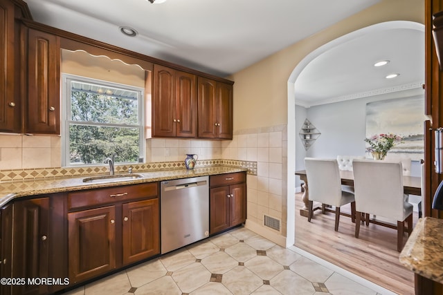 41 Alan Ter, Howell, NJ 07731 - kitchen featuring stainless steel dishwasher, arched walkways, light stone counters, light tile patterned flooring, and ornamental molding
