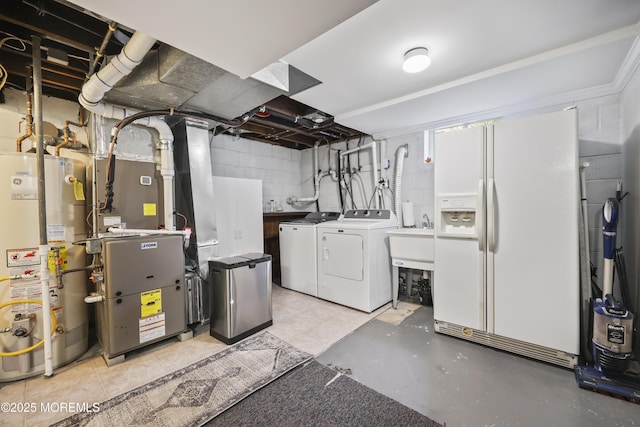 41 Alan Ter, Howell, NJ 07731 - basement featuring water heater, white fridge with ice dispenser, washing machine and clothes dryer, heating unit, and concrete block wall