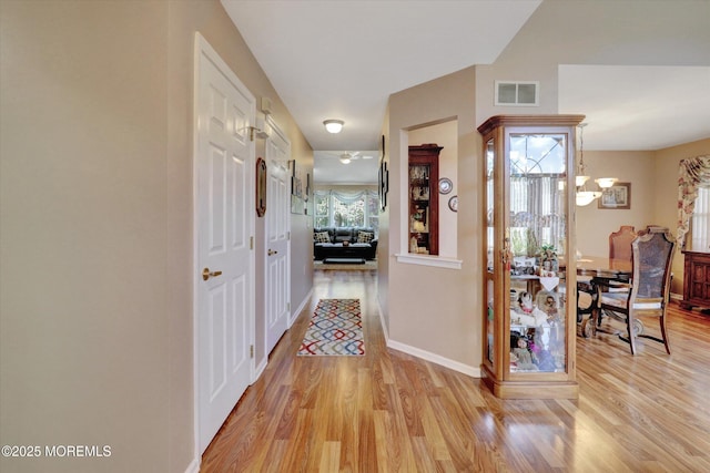 6 Thatcher Ct, Jackson, NJ 08527 - hallway featuring light wood finished floors and a chandelier