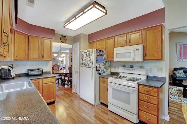 6 Thatcher Ct, Jackson, NJ 08527 - kitchen featuring white appliances, backsplash, light wood-style floors, a chandelier, and dark countertops