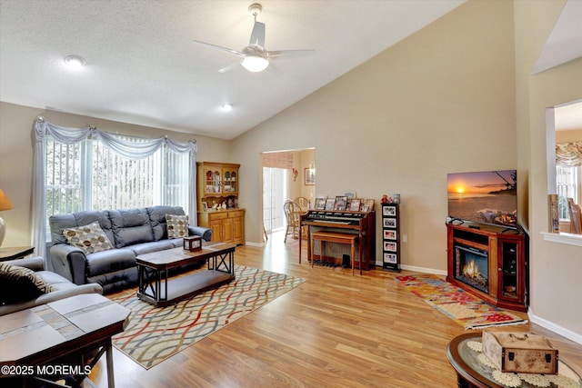 6 Thatcher Ct, Jackson, NJ 08527 - living room featuring a ceiling fan, wood finished floors, a glass covered fireplace, and high vaulted ceiling