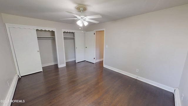 574 Main St, Sayreville, NJ 08872 - unfurnished bedroom with two closets, dark wood-style floors, baseboard heating, a baseboard heating unit, and ceiling fan
