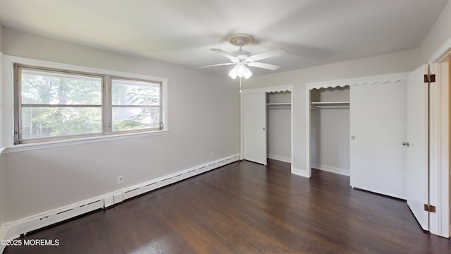 574 Main St, Sayreville, NJ 08872 - unfurnished bedroom with a baseboard radiator, two closets, and dark wood finished floors