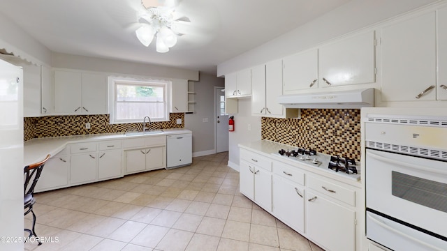 574 Main St, Sayreville, NJ 08872 - kitchen featuring white appliances, under cabinet range hood, decorative backsplash, light countertops, and light tile patterned floors