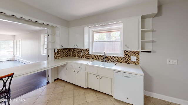 574 Main St, Sayreville, NJ 08872 - kitchen featuring white dishwasher, open shelves, decorative backsplash, and light countertops