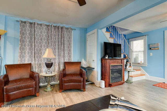 63 Asbury Ave, Ocean Grove, NJ 07756 - living room featuring wood finished floors, a ceiling fan, and a glass covered fireplace