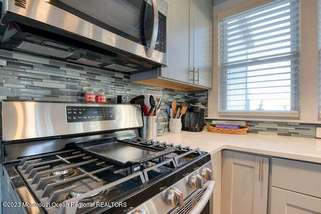 63 Asbury Ave, Ocean Grove, NJ 07756 - kitchen featuring stainless steel appliances, light countertops, and decorative backsplash