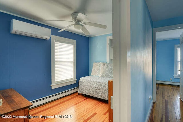 63 Asbury Ave, Ocean Grove, NJ 07756 - sitting room with a baseboard radiator, an AC wall unit, hardwood / wood-style floors, and a ceiling fan