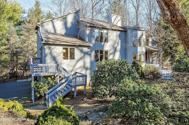 7 Jayhawk Way, Holmdel, NJ 07733 - view of front facade featuring a chimney, roof with shingles, and stairs