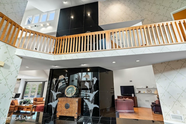 7 Jayhawk Way, Holmdel, NJ 07733 - staircase featuring wallpapered walls, an accent wall, a high ceiling, and recessed lighting