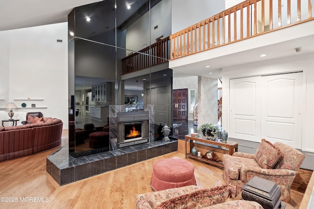 7 Jayhawk Way, Holmdel, NJ 07733 - living area with a towering ceiling, wood finished floors, a fireplace, and wallpapered walls
