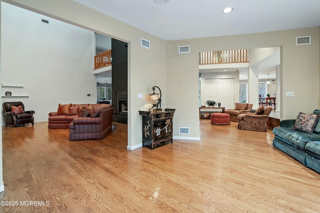 7 Jayhawk Way, Holmdel, NJ 07733 - living room featuring wood finished floors, a towering ceiling, recessed lighting, and a fireplace