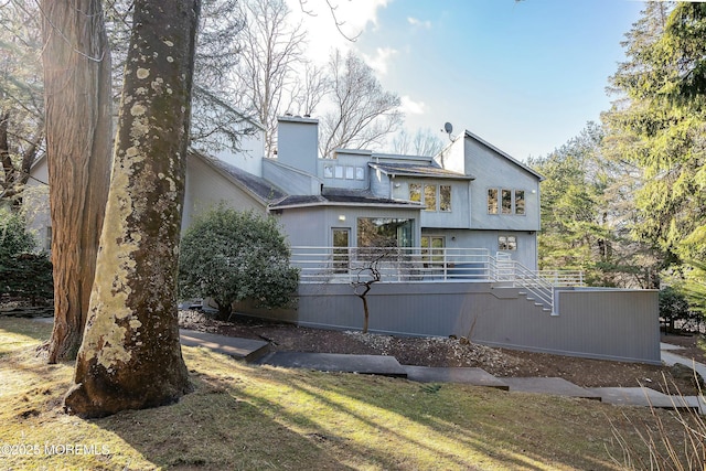 7 Jayhawk Way, Holmdel, NJ 07733 - view of property exterior with stairway, a chimney, a deck, and a shingled roof