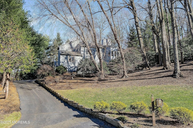 7 Jayhawk Way, Holmdel, NJ 07733 - view of front of house with a front yard, asphalt driveway, and a chimney
