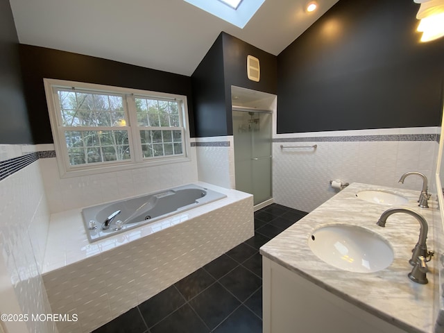 7 Erte Pl, Marlboro, NJ 07746 - bathroom with tile walls, a stall shower, tile patterned flooring, a tub with jets, and a skylight