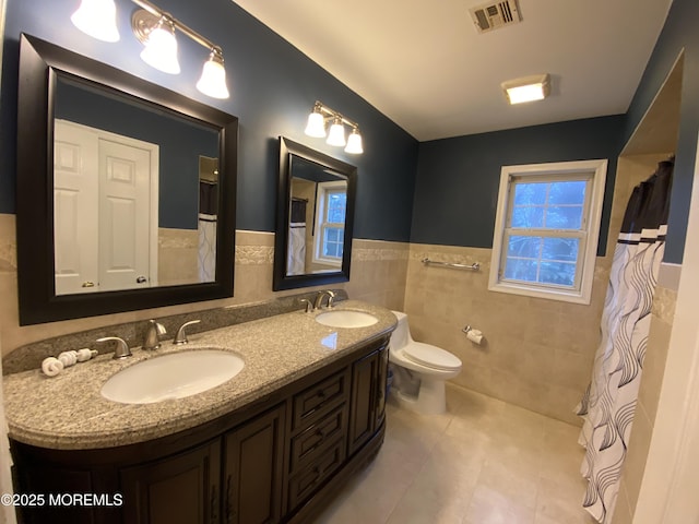 7 Erte Pl, Marlboro, NJ 07746 - bathroom featuring tile patterned floors, tile walls, double vanity, wainscoting, and a shower with curtain
