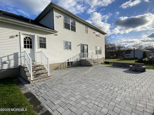 7 Erte Pl, Marlboro, NJ 07746 - back of property with an outdoor fire pit, a patio area, and entry steps