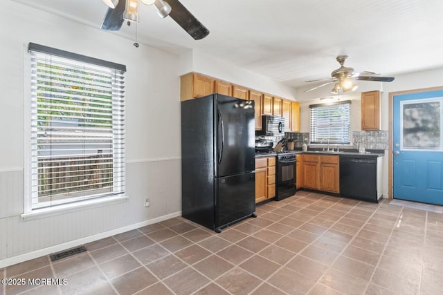 45 Letts Landing Rd, Waretown, NJ 08758 - kitchen with black appliances, a ceiling fan, a wainscoted wall, decorative backsplash, and dark countertops