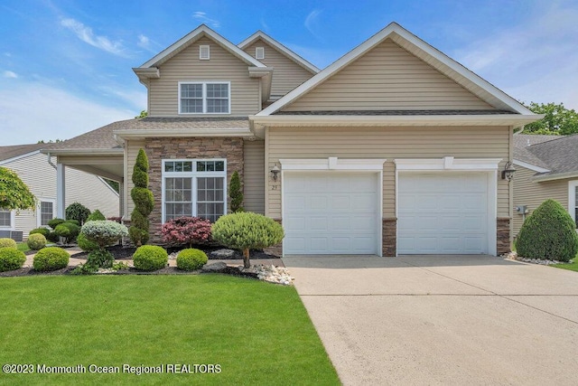 25 Merion Ln, Jackson, NJ 08527 - traditional-style home featuring concrete driveway, a garage, a front lawn, stone siding, and a shingled roof