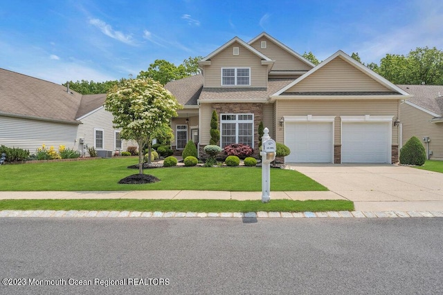 25 Merion Ln, Jackson, NJ 08527 - traditional-style house featuring a front lawn, driveway, an attached garage, and roof with shingles