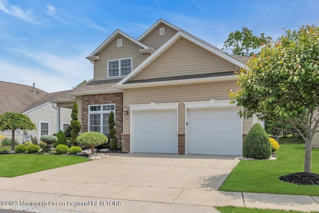 25 Merion Ln, Jackson, NJ 08527 - traditional-style home featuring driveway, stone siding, a front lawn, and an attached garage