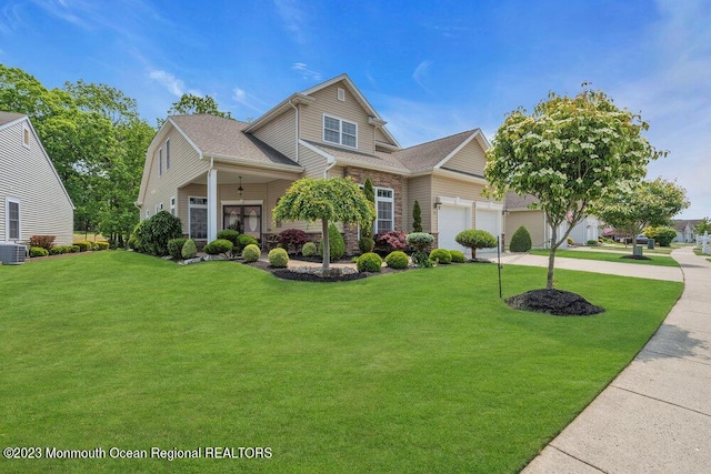 25 Merion Ln, Jackson, NJ 08527 - traditional home with a front lawn, concrete driveway, an attached garage, and a shingled roof