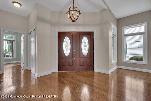 25 Merion Ln, Jackson, NJ 08527 - foyer entrance featuring a chandelier, healthy amount of natural light, and wood finished floors