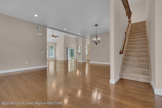 25 Merion Ln, Jackson, NJ 08527 - unfurnished living room with ceiling fan, vaulted ceiling, stairs, wood finished floors, and a chandelier