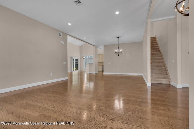 25 Merion Ln, Jackson, NJ 08527 - unfurnished living room with a chandelier, lofted ceiling, wood finished floors, stairs, and recessed lighting
