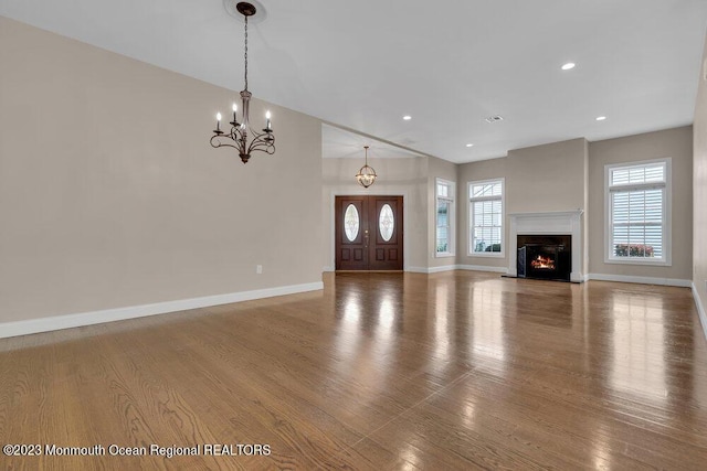 25 Merion Ln, Jackson, NJ 08527 - unfurnished living room featuring wood finished floors, a chandelier, recessed lighting, and a lit fireplace