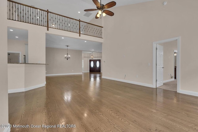 25 Merion Ln, Jackson, NJ 08527 - unfurnished living room with a ceiling fan, a chandelier, a high ceiling, wood finished floors, and recessed lighting