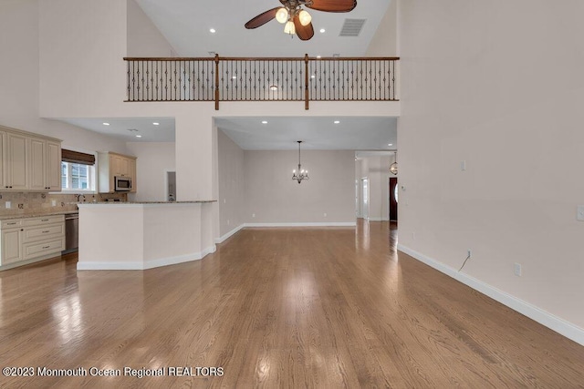 25 Merion Ln, Jackson, NJ 08527 - unfurnished living room featuring a high ceiling, a ceiling fan, a chandelier, light wood-style flooring, and recessed lighting