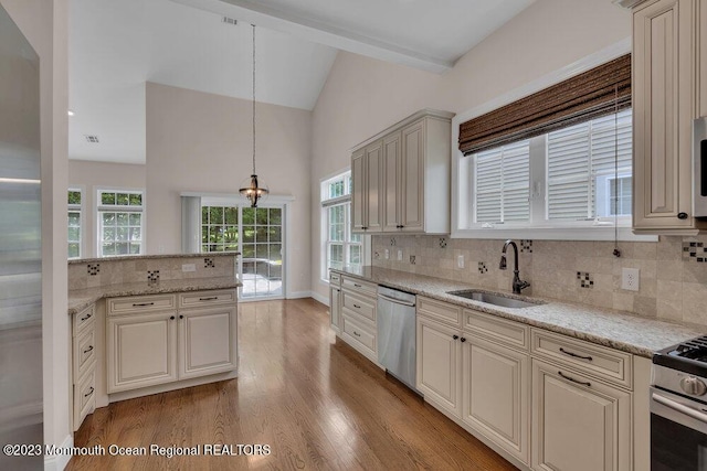 25 Merion Ln, Jackson, NJ 08527 - kitchen featuring appliances with stainless steel finishes, cream cabinets, tasteful backsplash, light wood-style flooring, and high vaulted ceiling