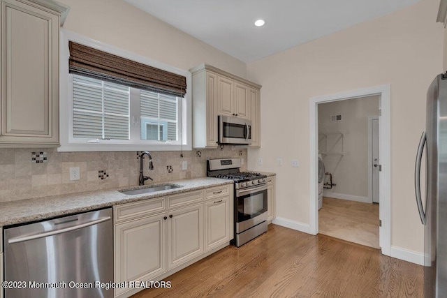25 Merion Ln, Jackson, NJ 08527 - kitchen with stainless steel appliances, cream cabinetry, tasteful backsplash, light wood-style floors, and recessed lighting
