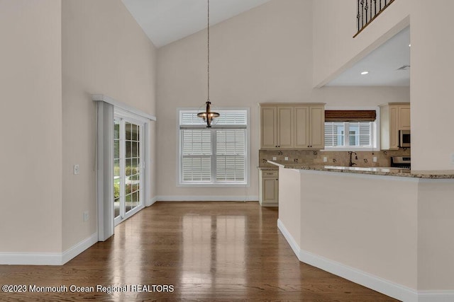 25 Merion Ln, Jackson, NJ 08527 - kitchen with cream cabinets, high vaulted ceiling, stainless steel appliances, healthy amount of natural light, and decorative backsplash