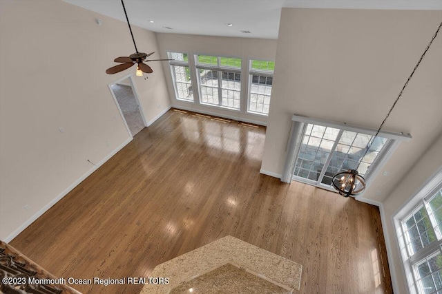 25 Merion Ln, Jackson, NJ 08527 - unfurnished living room featuring a towering ceiling, ceiling fan, plenty of natural light, and wood finished floors