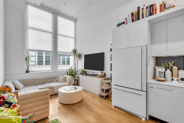 50 Dey St Unit 434, Jersey City, NJ 07306 - living area with light wood-style flooring and a towering ceiling