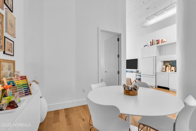 50 Dey St Unit 434, Jersey City, NJ 07306 - dining space with light wood-style floors and a towering ceiling