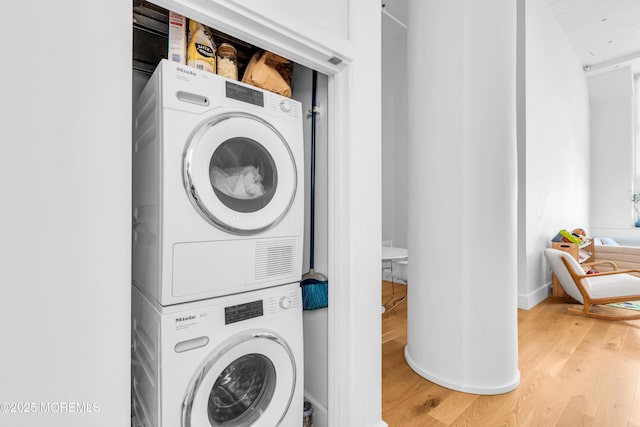 50 Dey St Unit 434, Jersey City, NJ 07306 - washroom featuring stacked washing machine and dryer and light wood-style floors