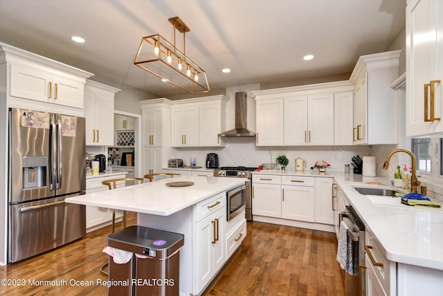 767 Hemlock Rd, Union, NJ 07083 - kitchen featuring stainless steel appliances, wall chimney range hood, white cabinetry, dark wood-style floors, and recessed lighting