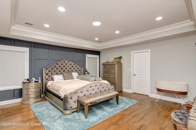 767 Hemlock Rd, Union, NJ 07083 - bedroom featuring a raised ceiling, crown molding, a decorative wall, light wood-type flooring, and recessed lighting