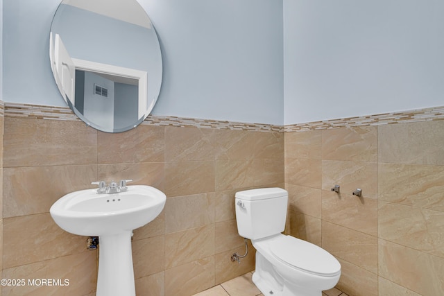 25 Rockefeller Dr, Lakewood, NJ 08701 - bathroom with tile walls, tile patterned flooring, and a wainscoted wall