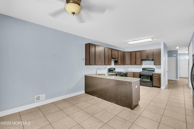 25 Rockefeller Dr, Lakewood, NJ 08701 - kitchen with black range with gas cooktop, gas stove, a peninsula, light tile patterned floors, and under cabinet range hood